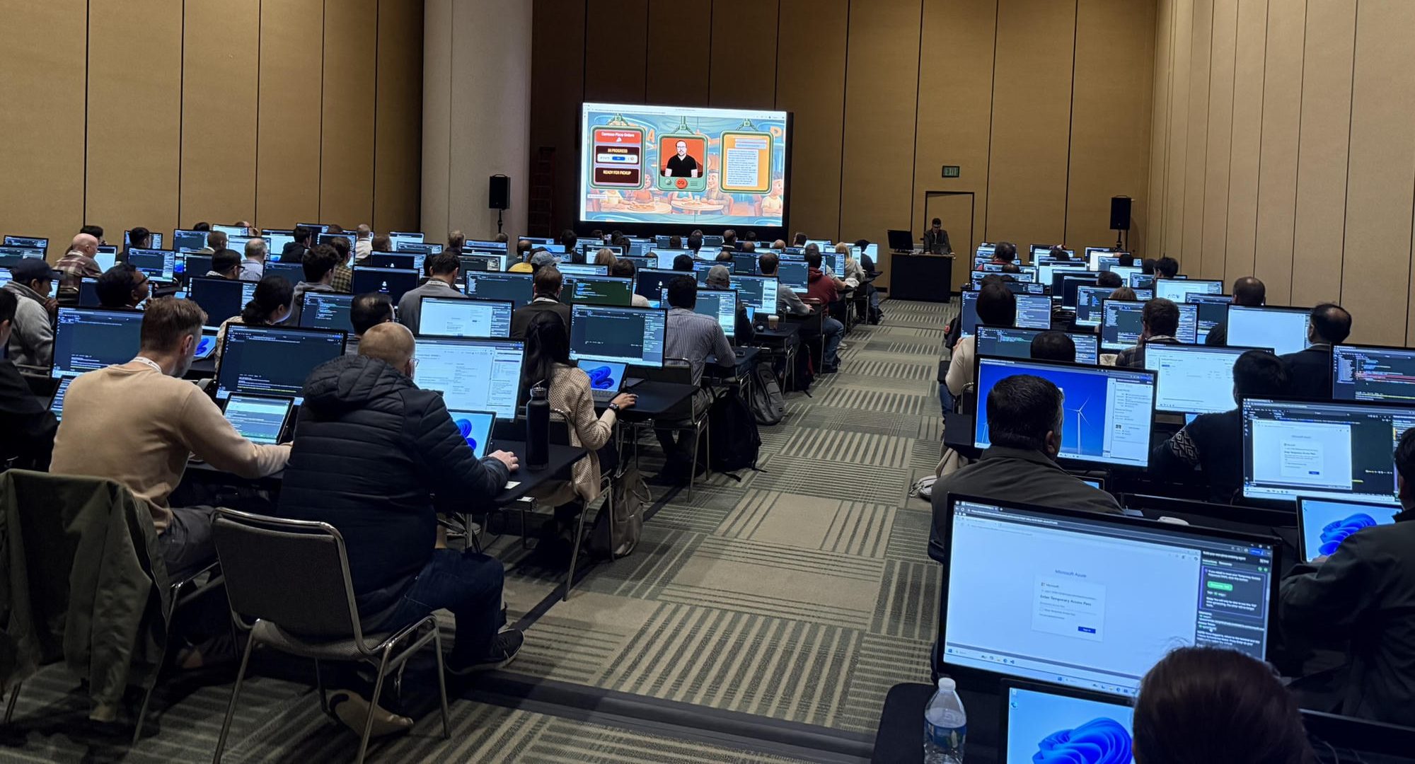 A packed hands-on lab room where everyone is building along on their own laptop